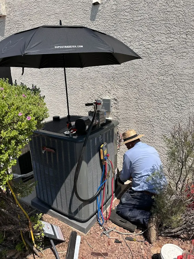 HVAC technician performing outdoor AC maintenance in Summerfield