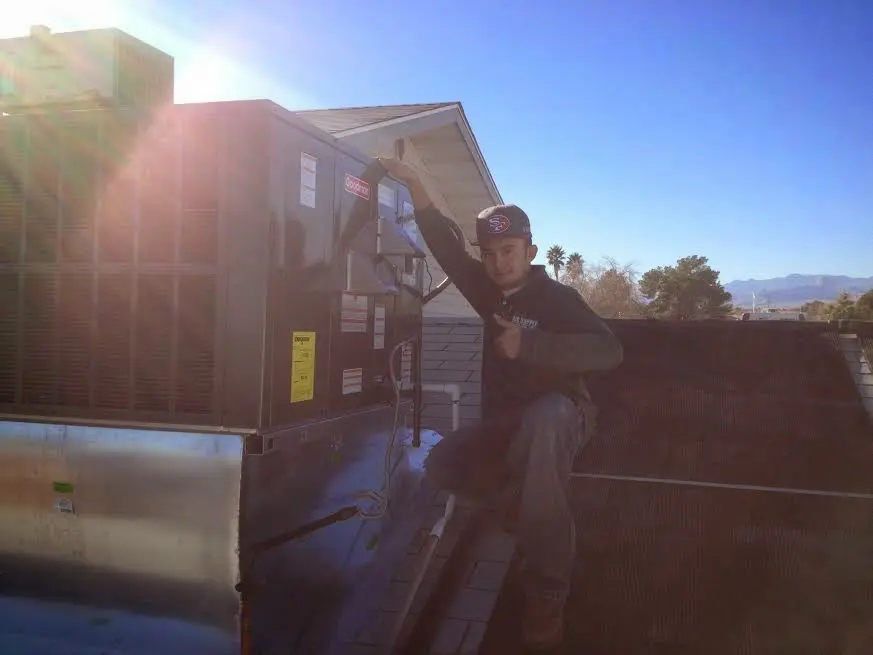 HVAC technician performing AC Tune-Up on a rooftop unit in Summerfield
